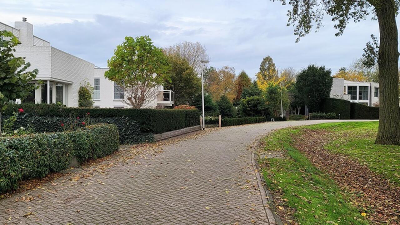 Overweersepolderdijk - weg met bocht, en links de bebouwing (witte bungalows)